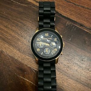 Michael Kors black and gold watch.